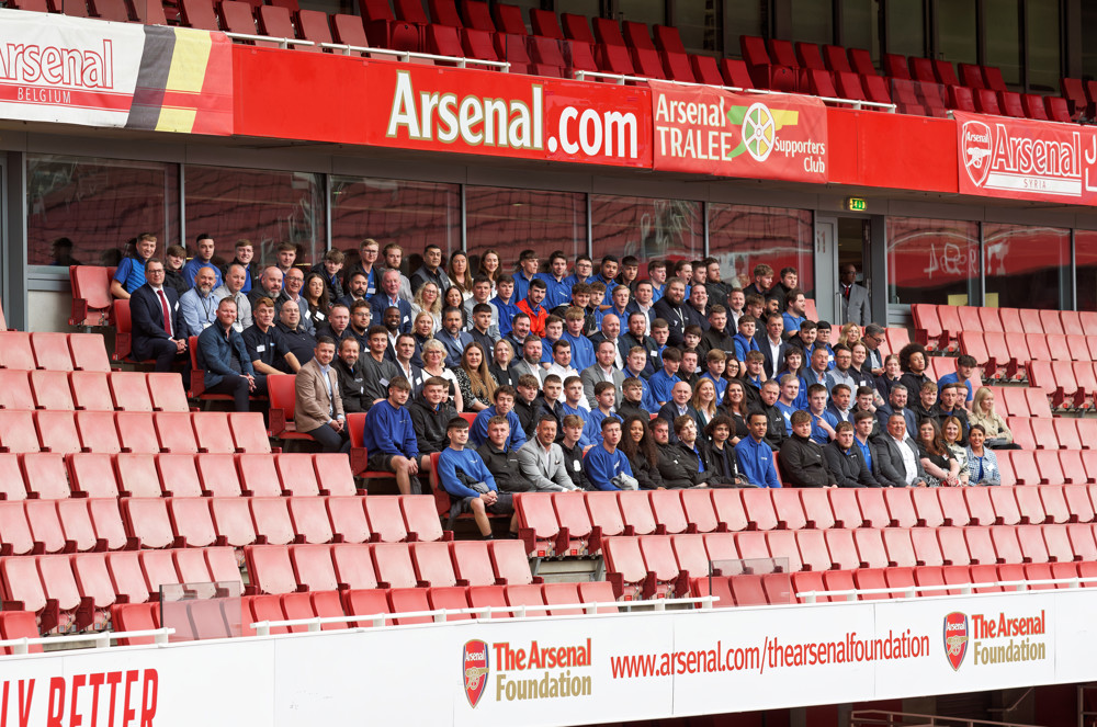 Group Sitting In Football Stadium
