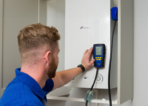 Engineer Using Analyser On Boiler