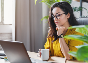 Lady On Laptop With Mug