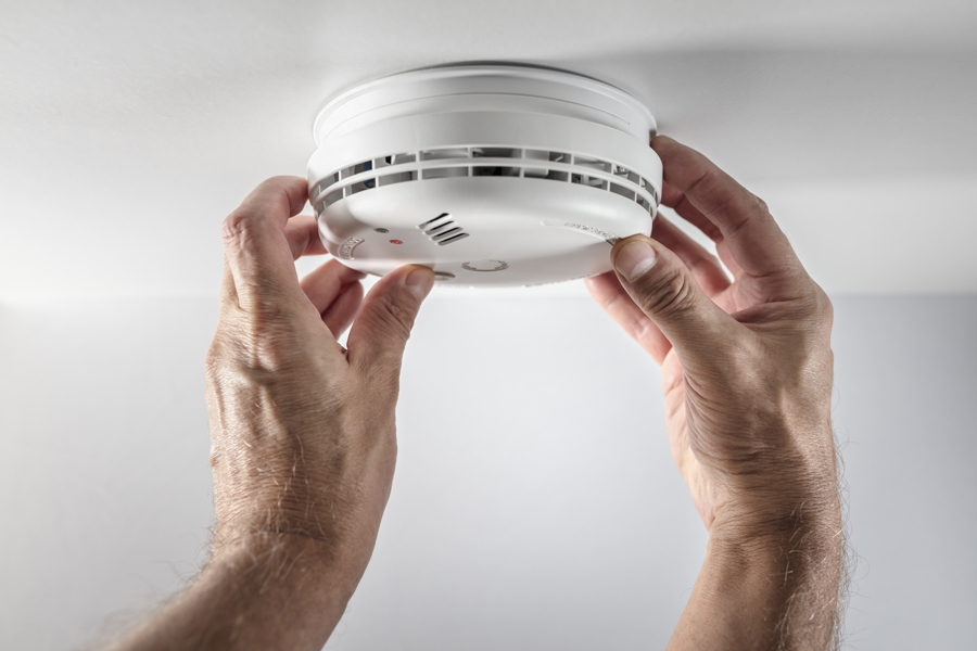 Smoke alarm being checked