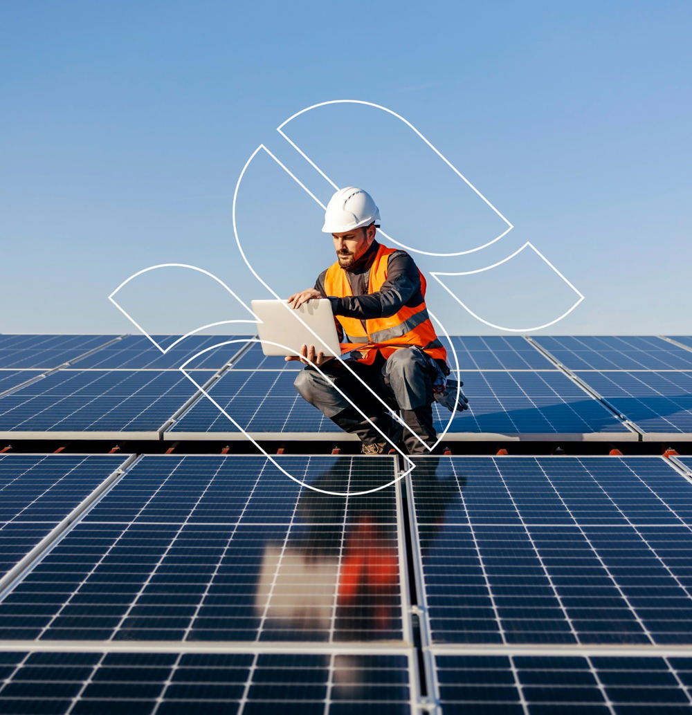 Engineer Looking At Solar Panels Plans Edit@2X