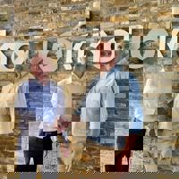 Picture of handshake and 2 men smiling
