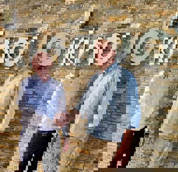Picture of handshake and 2 men smiling